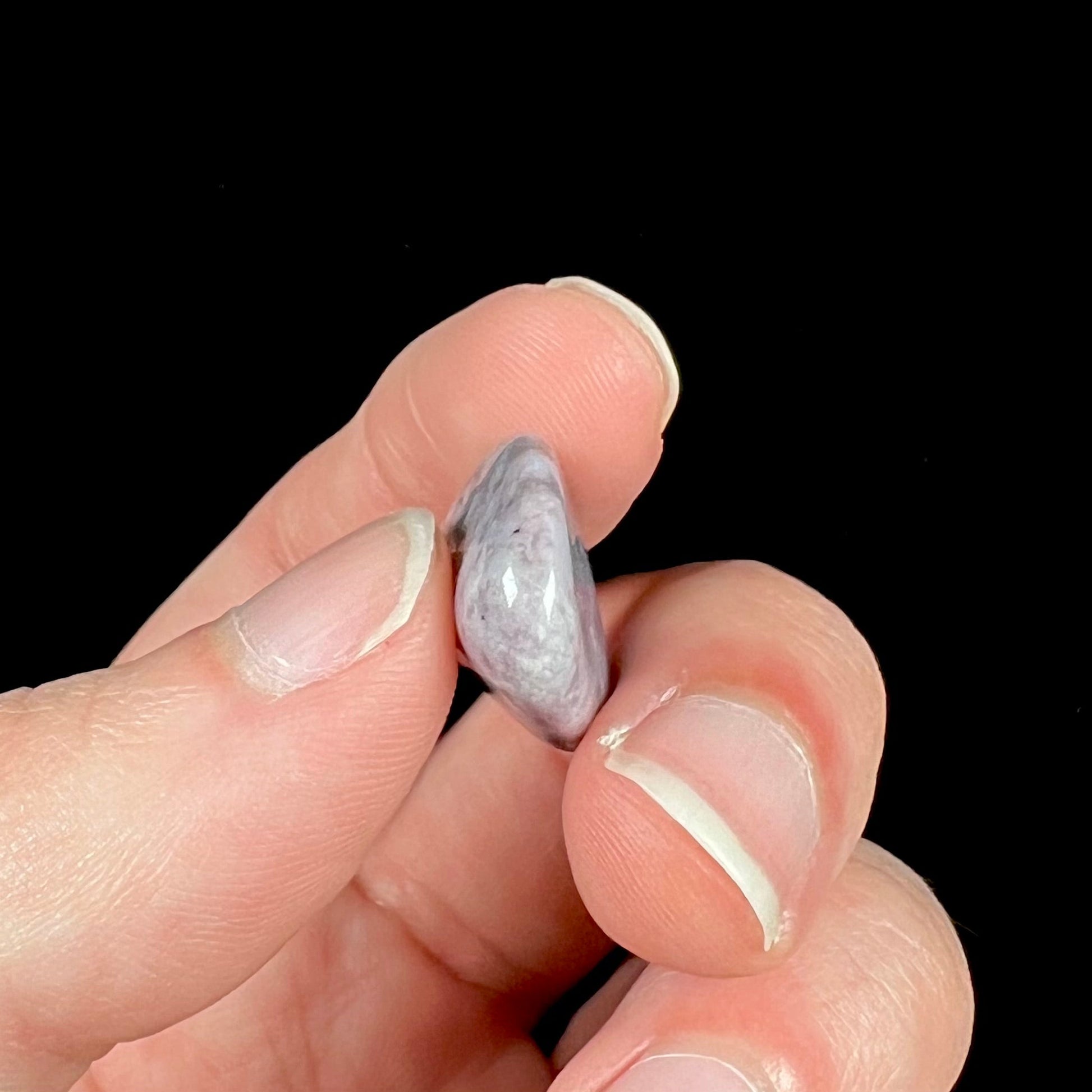 A tumbled purple turkiyenite jade stone from Bursa, Turkey.