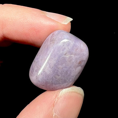 A tumbled Turkish purple jade stone, also known as turkiyenite.