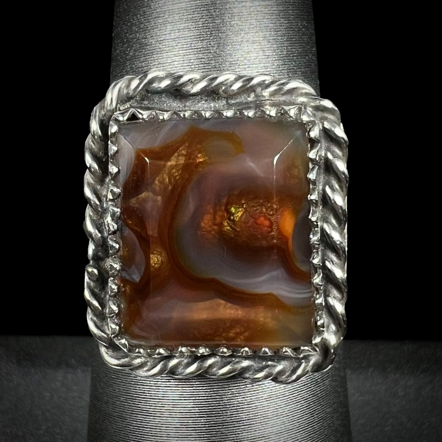 Rectangle cut fire agate ring with sterling silver rope design shown from the front view.