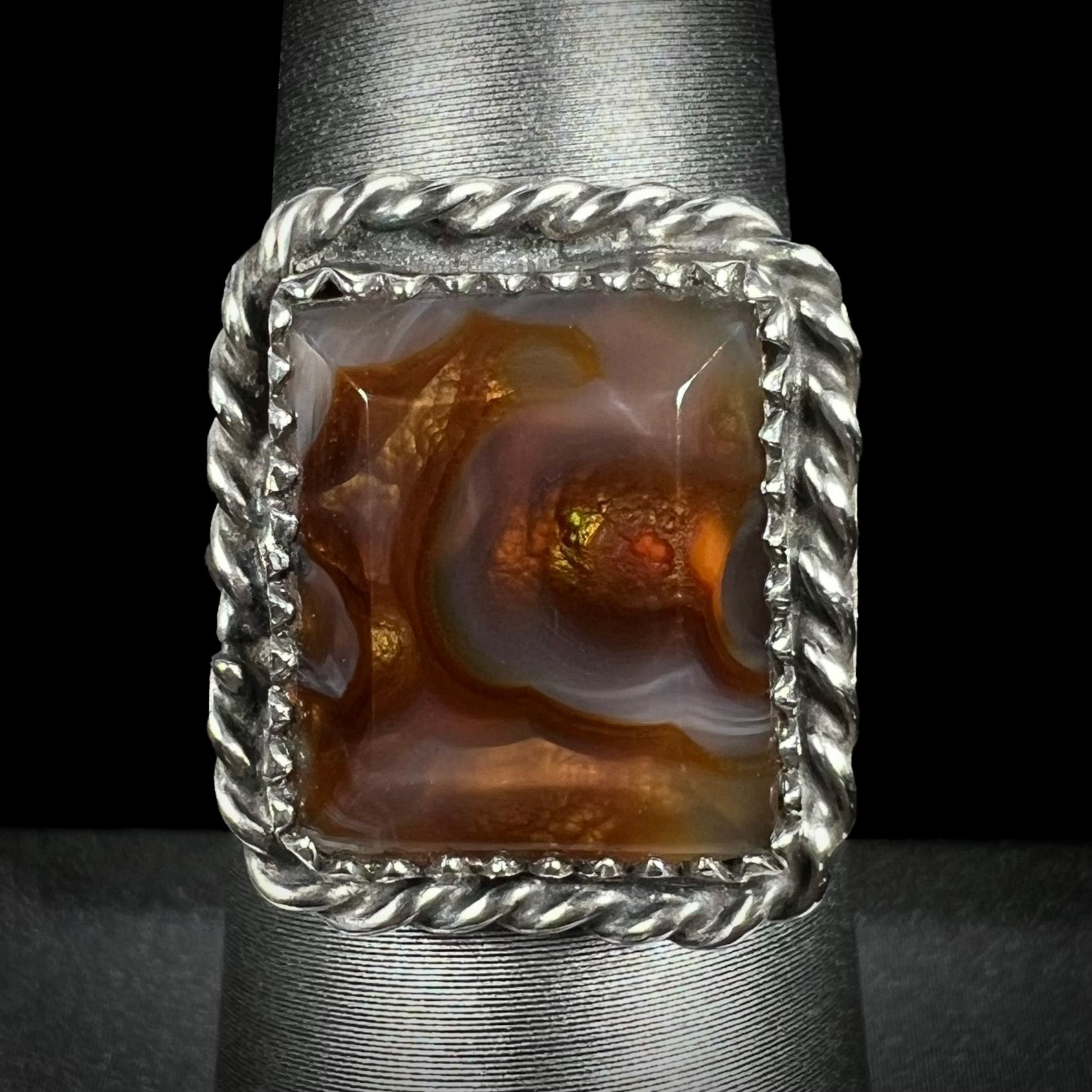 Rectangle cut fire agate ring with sterling silver rope design shown from the front view.