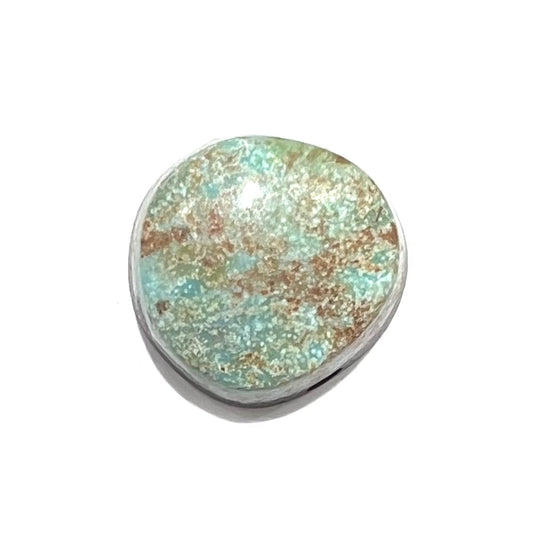 A loose, off-round cabochon cut turquoise stone.  The stone is light blue with a red webbed matrix.