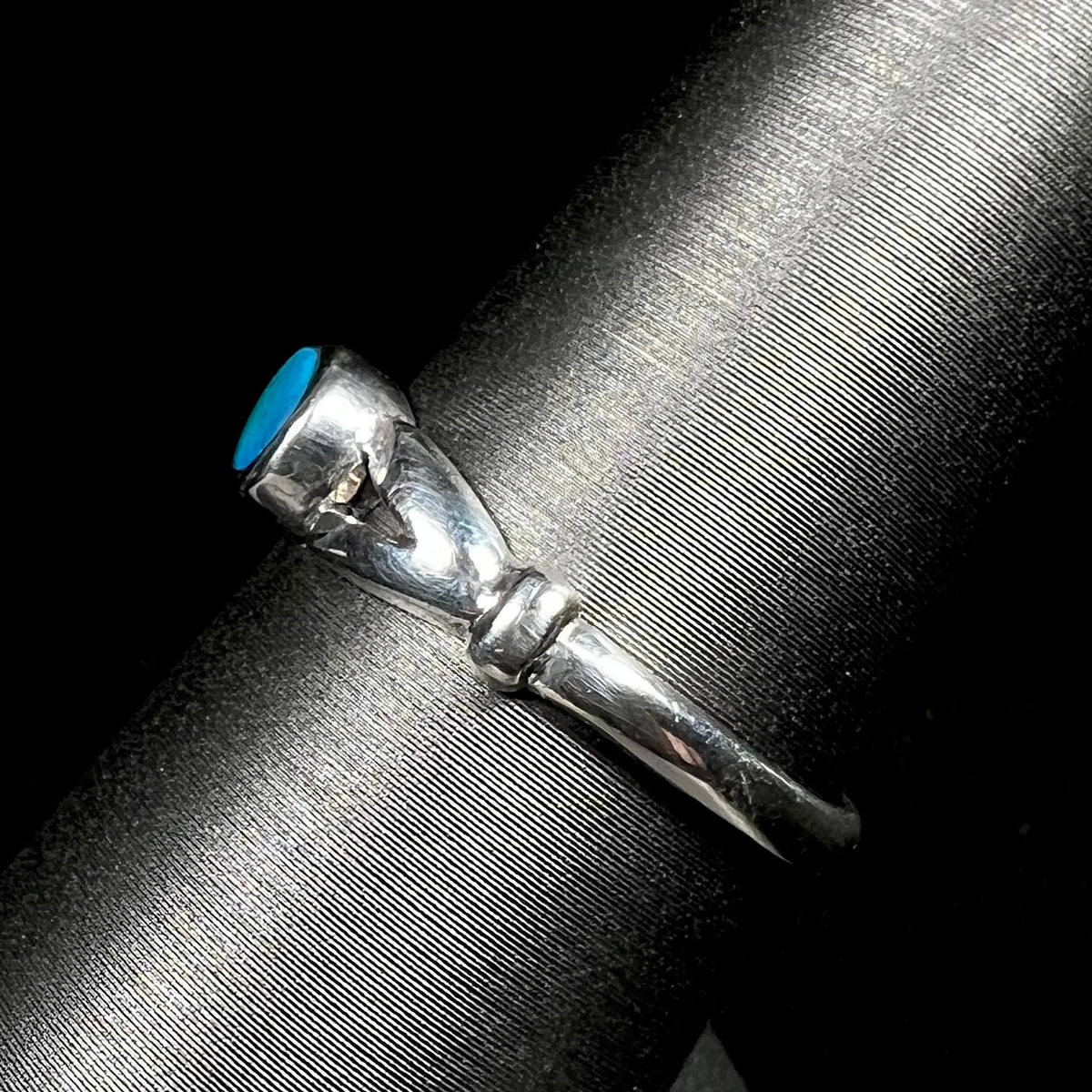 Side view of refurbished sterling silver opal doublet ring on display showing split shank design