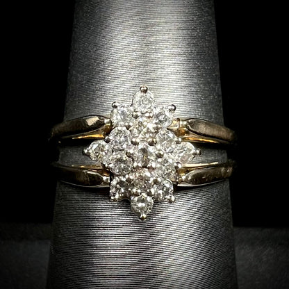 Vintage 1980s era diamond cluster flip ring in 14k gold shown close-up on ring display