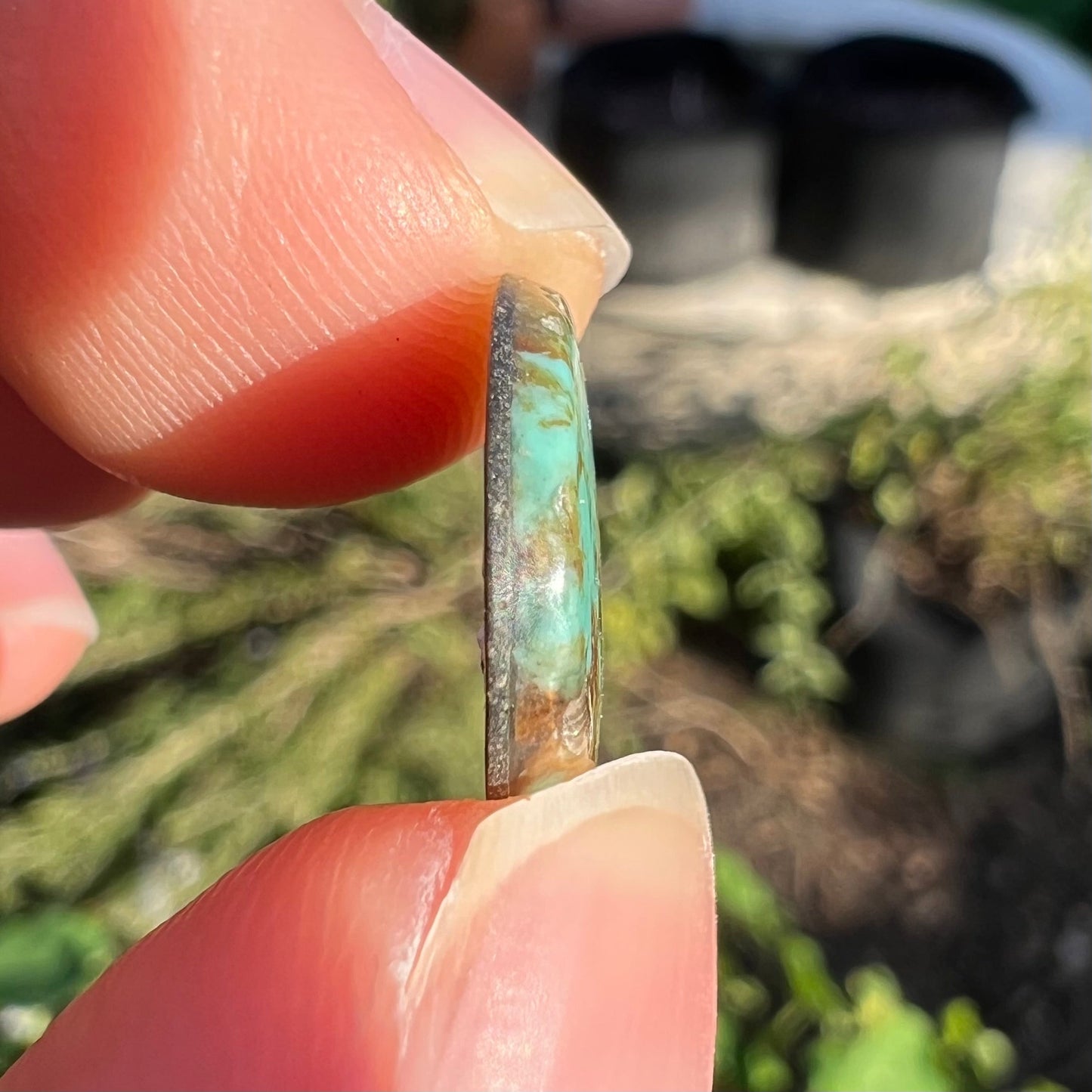 A loose, freeform cabochon cut Royston turquoise stone.