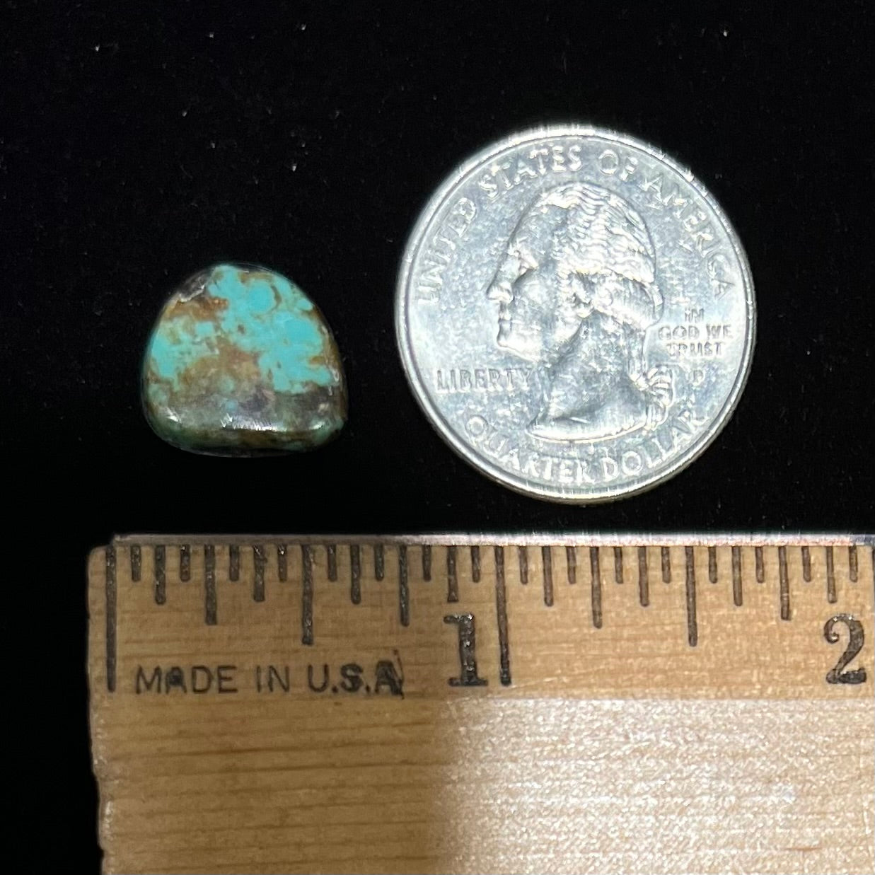 A loose, freeform cabochon cut Royston turquoise stone.