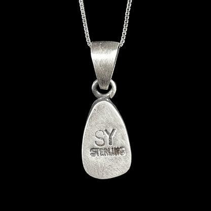 A handmade, satin finish sterling silver pendant set with a drop shaped boulder opal stone.