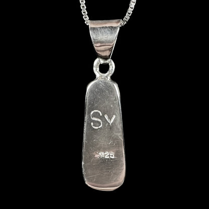 A sterling silver necklace bezel set with a natural Australian boulder opal stone.  The stone shines colors of blue, green, and purple.