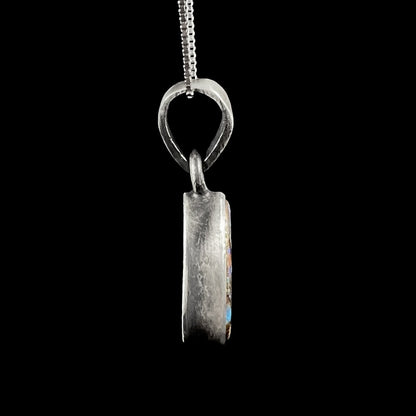 A handmade, satin finish sterling silver pendant set with a drop shaped boulder opal stone.