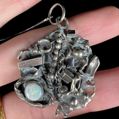 A scrap silver opal shipwreck necklace shown close-up from the front view.