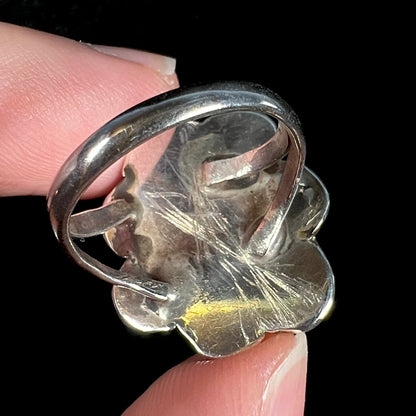 Scratched back of vintage sterling silver fire agate ring shown up close.