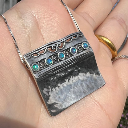 A handmade sterling silver five-stone opal necklace with a hammered finish by Israeli designer, Shablool Didae.