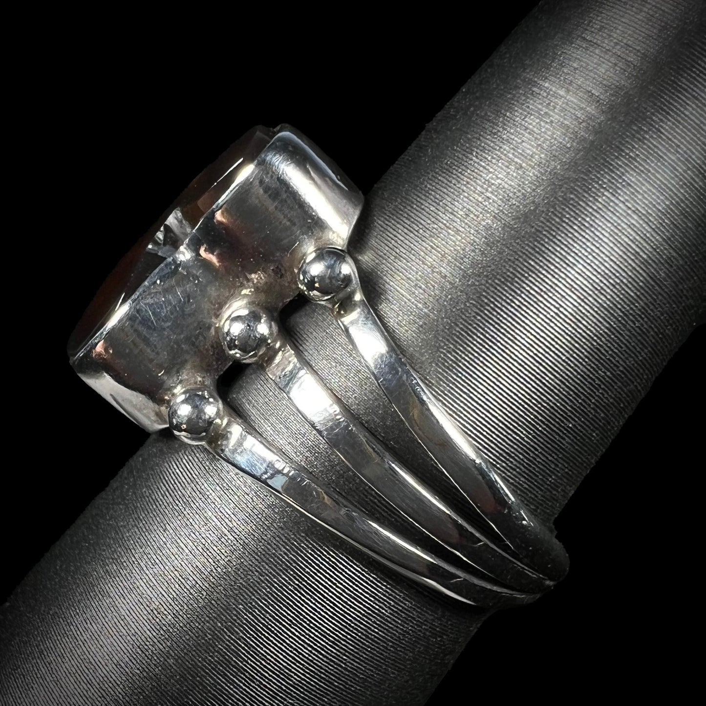 Side profile of sterling silver fire agate ring with visible split shank.