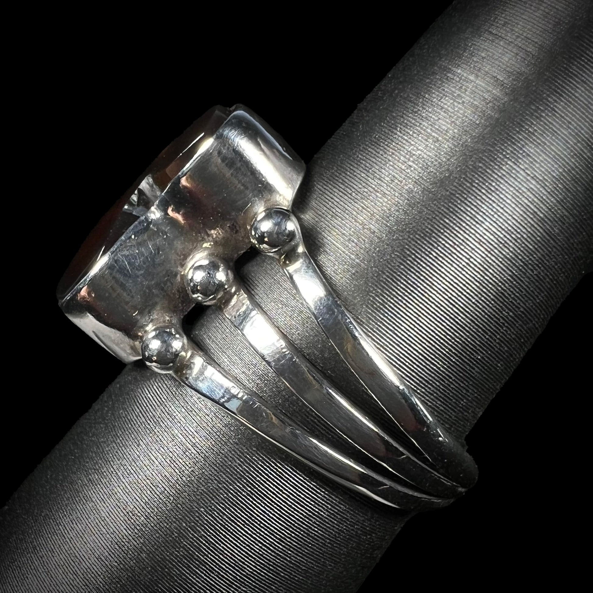 Side profile of sterling silver fire agate ring with visible split shank.