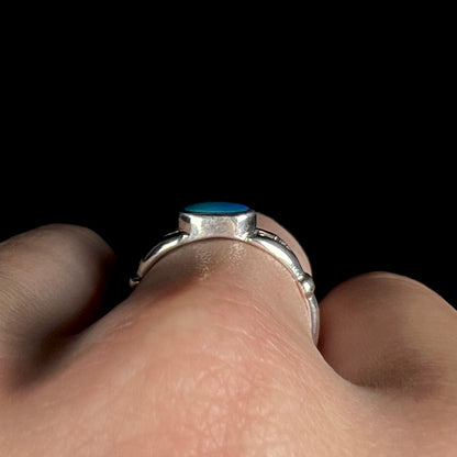 Side profile gallery view of sterling silver bezel set opal doublet solitaire ring, worn on finger