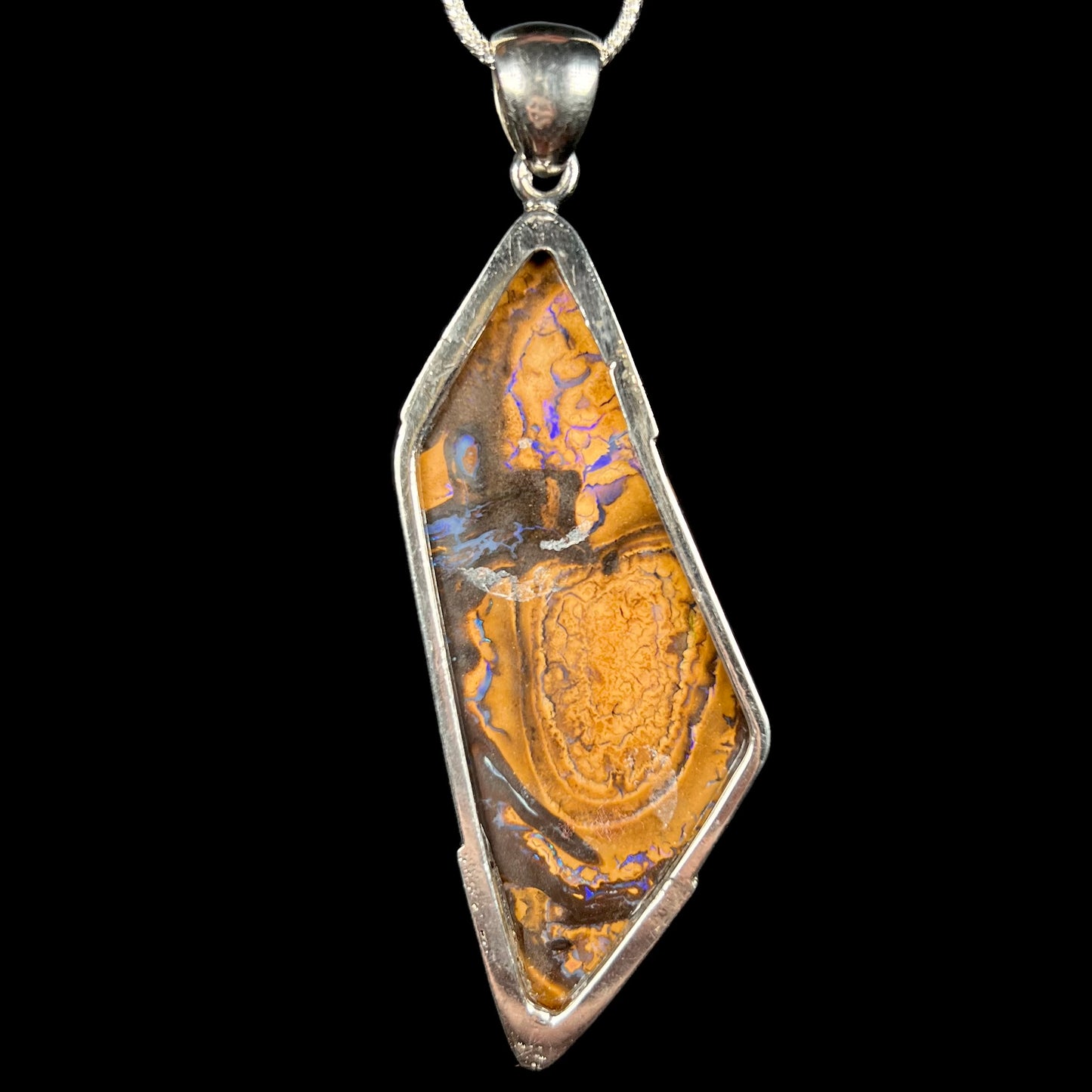Back side of sterling silver boulder opal men's pendant showing brown ironstone matrix