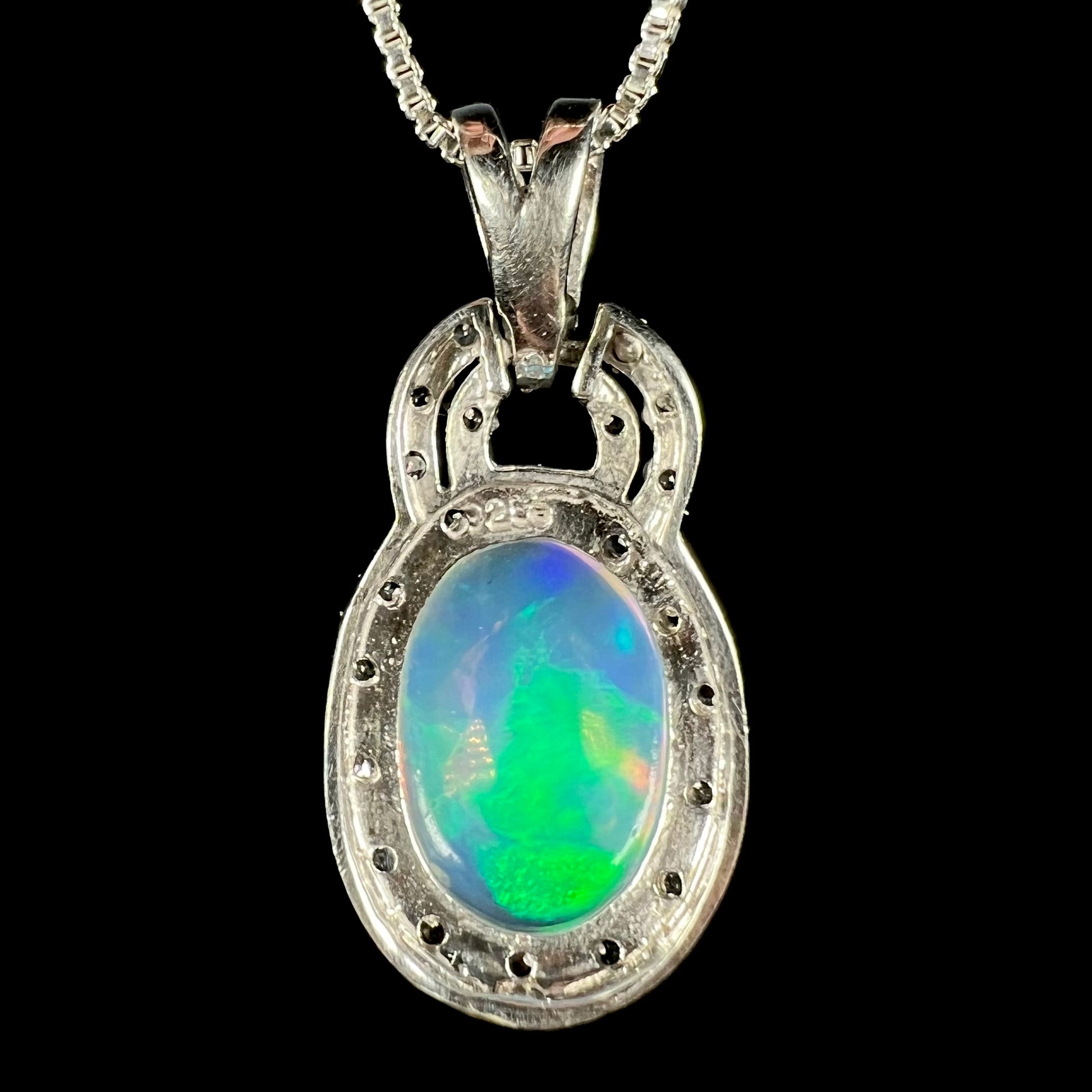 Back side of sterling silver Ethiopian opal pendant showing "925" hallmark stamp and back of opal
