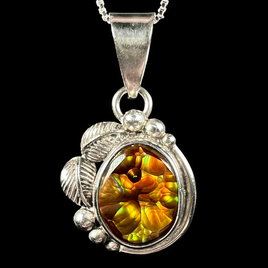 Close-up of sterling silver Mexican fire agate pendant with American Southwest-inspired leaf and bead design, shown on chain.