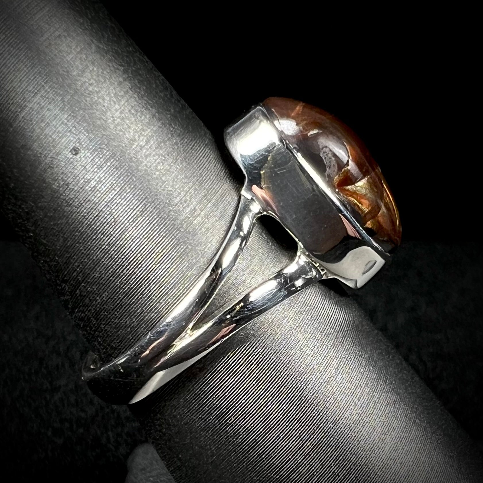 Side view of a sterling silver Mexican fire agate ring with a split shank.