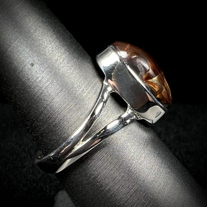 Side view of a sterling silver Mexican fire agate ring with a split shank.
