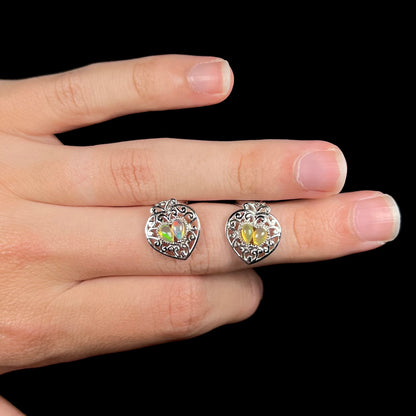 A pair of dangling sterling silver filigree heart earrings, each set with two Ethiopian opals.