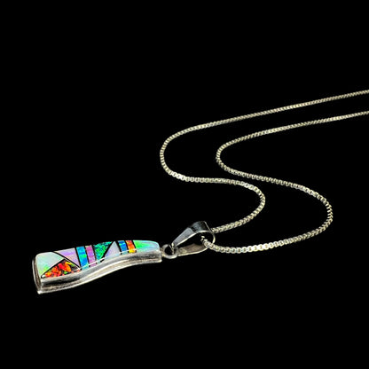 A sterling silver Navajo-made opal inlay necklace shown laying at an angle against a black background.