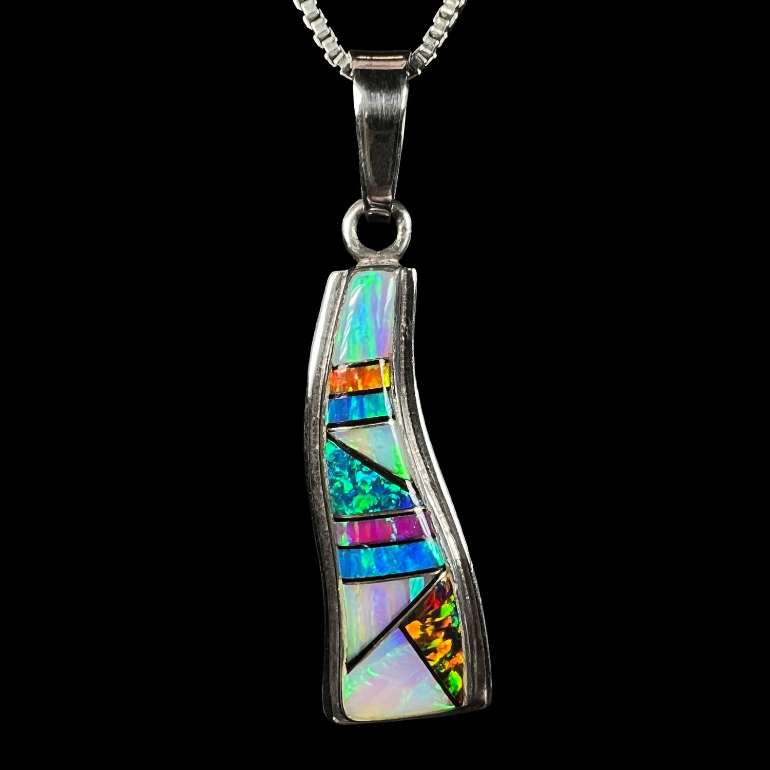 A sterling silver Navajo lab-created opal inlay pendant made by Johnson Ralph, shown against a black background.