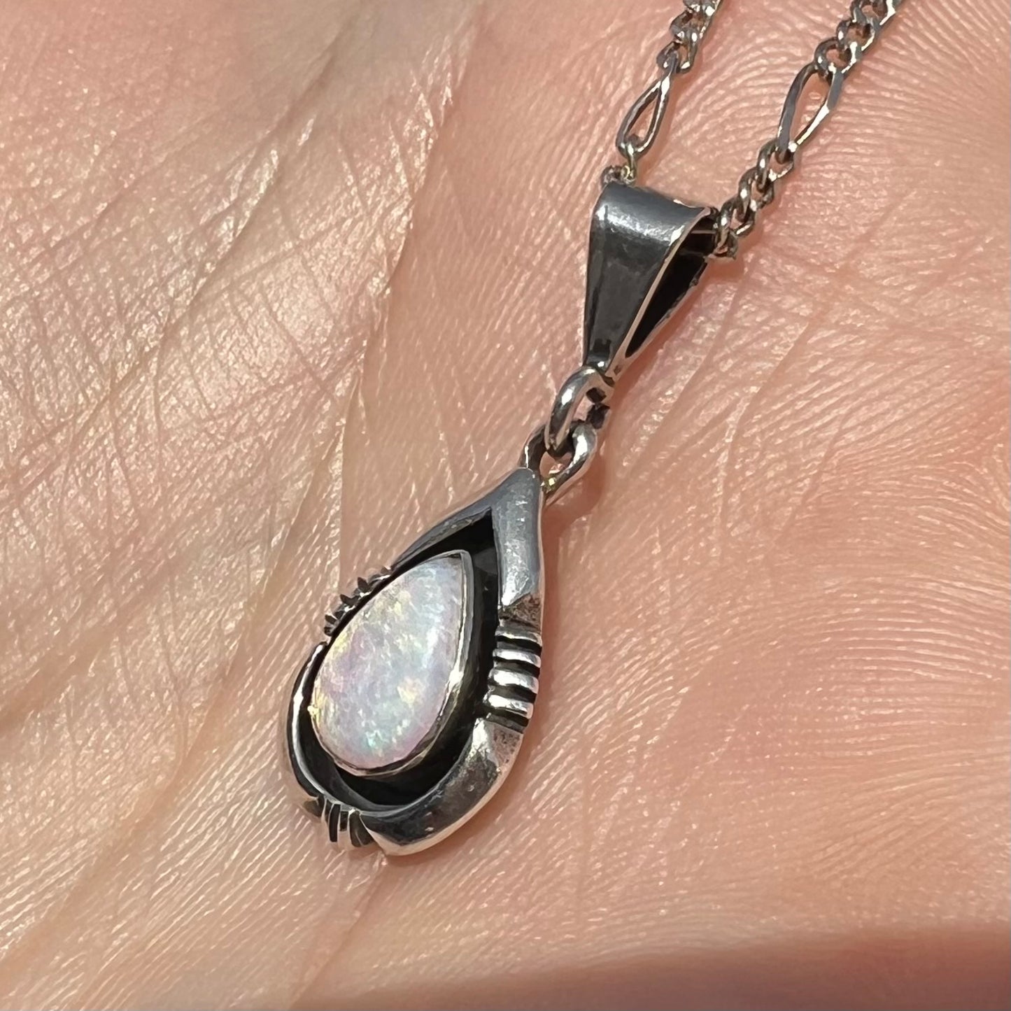 A pear shaped sterling silver Navajo pendant set with a green Australian opal made by artist, Chris Charley.