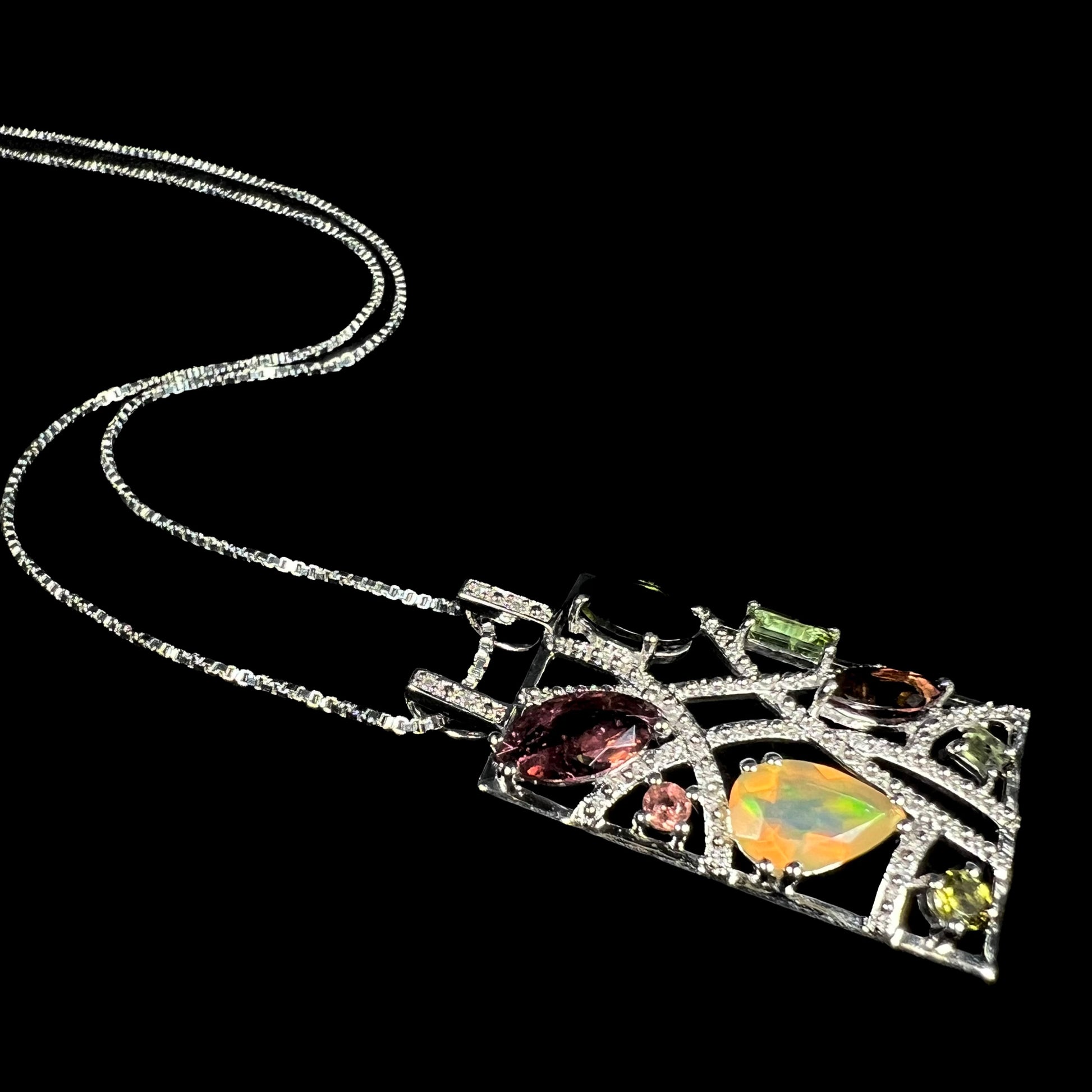 A sterling silver multi-gemstone necklace set with Ethiopian opal, tourmaline, and diamonds.