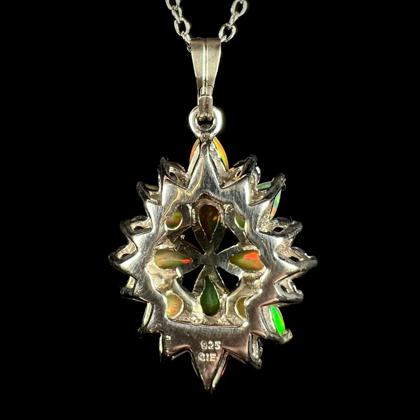 Back view of a silver opal cluster necklace.  The stamps "925" and "GIE" are seen in the silver.