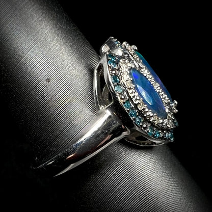 Side view of a sterling silver opal and diamond ring, focused in on the ring's metal shank.