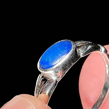 Close-up of the scratched surface of a blue opal doublet mounted in an estate sterling silver solitaire ring