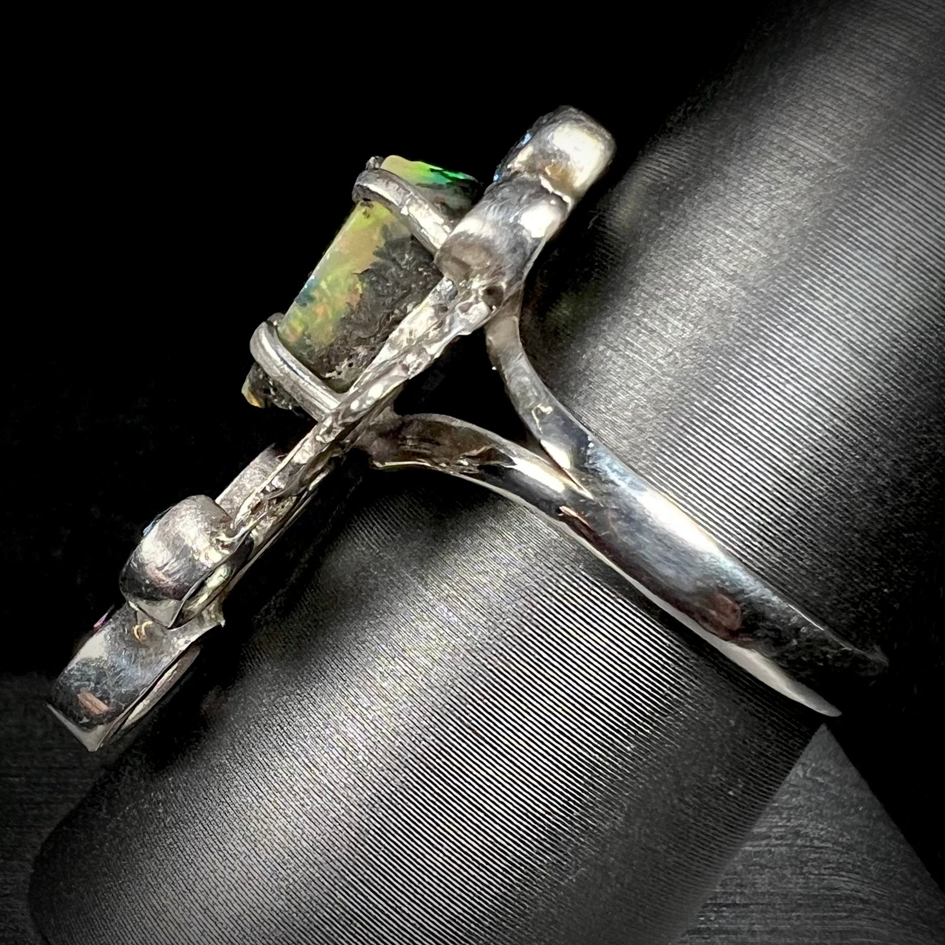 Side view of a men's handmade silver ring set with a rough opal from Virgin Valley, Nevada.