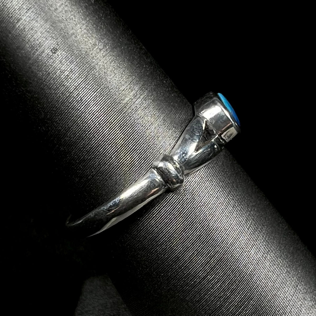 Side view of silver opal ring with polished split shank