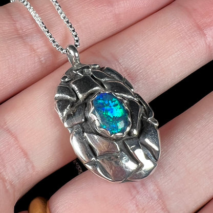 A unisex sterling silver pinecone-inspired opal triplet necklace.