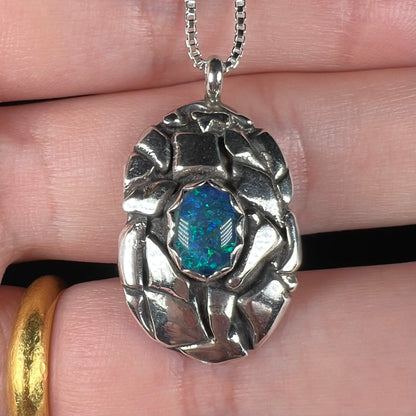 A unisex sterling silver pinecone-inspired opal triplet necklace.