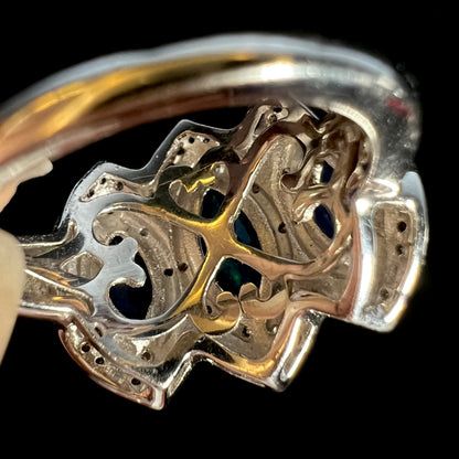 The undercarriage gallery of a silver opal ring showing filigree heart designs.