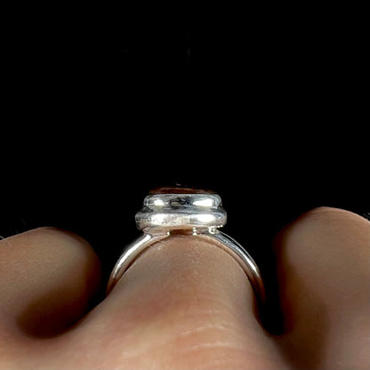 A ladies' fire agate ring set in a split-shank sterling silver mounting.
