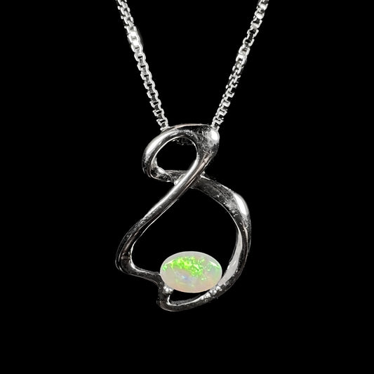A ladies' sterling silver necklace set with an oval cabochon cut natural white crystal opal with green fire.