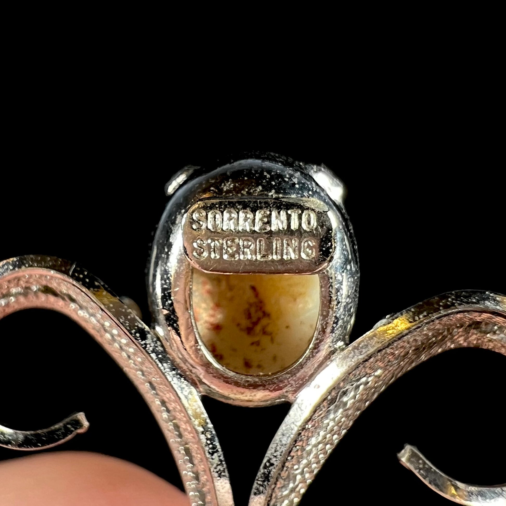 Back of a silver opal pendant showing the hallmarks, "SORRENTO" and "STERLING".