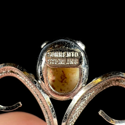 Back of a silver opal pendant showing the hallmarks, "SORRENTO" and "STERLING".