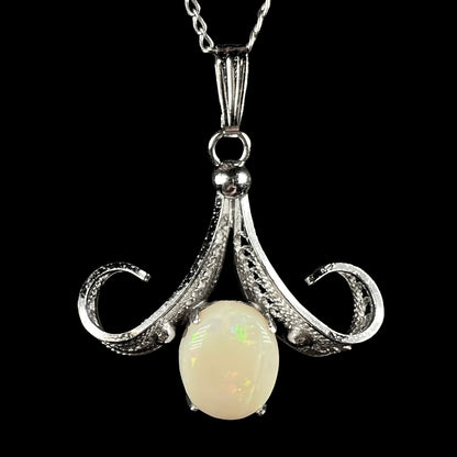 A Sorrento brand sterling silver Australian white opal pendant shown close-up against a black background.