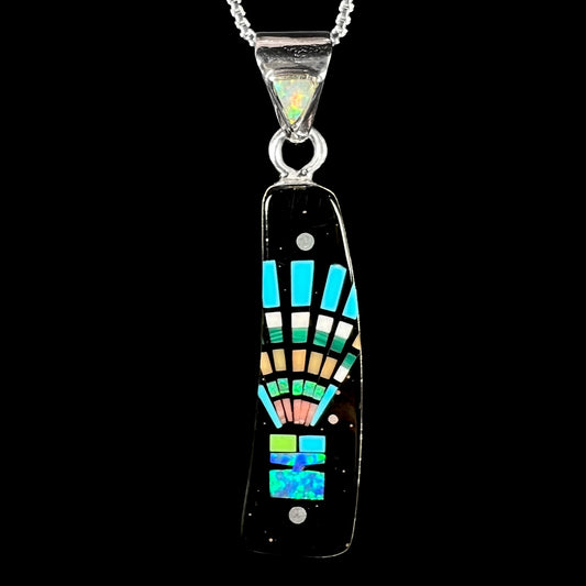 Front close-up of Southwest-style black onyx and lab-created opal inlay necklace with kachina motif shown on black background.