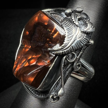 A men's silver, Southwest-style fire agate ring shown at an angled view.