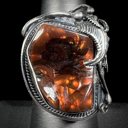 A men's silver, Southwest-style fire agate ring shown from the front view against a black background.