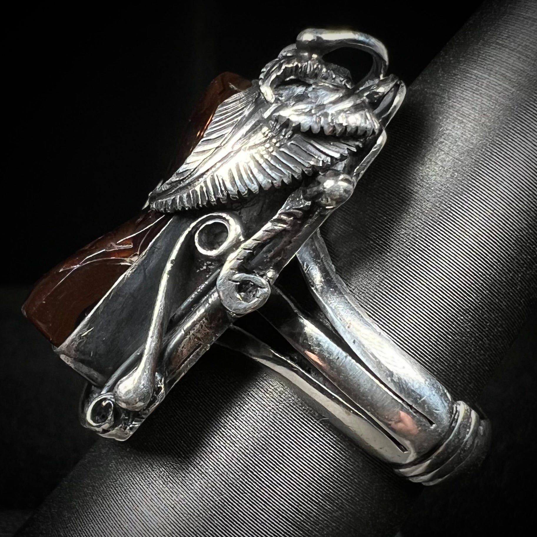 Side view of a men's silver, Southwest-style fire agate ring.