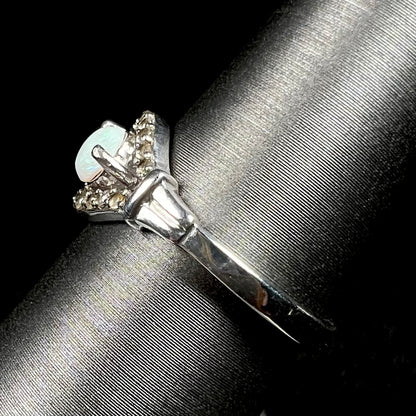 Side view of sterling silver Australian opal ring on ring display, focused on ring's polished shank