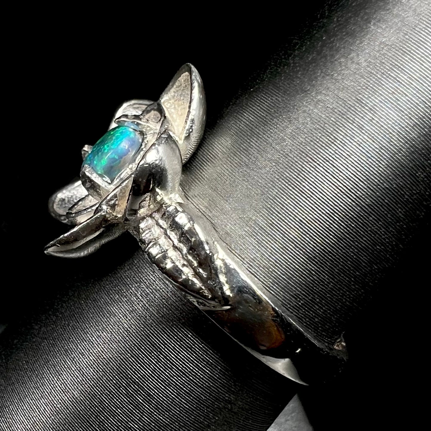 Side view of sterling silver lotus flower design ring set with solid Australian black opal