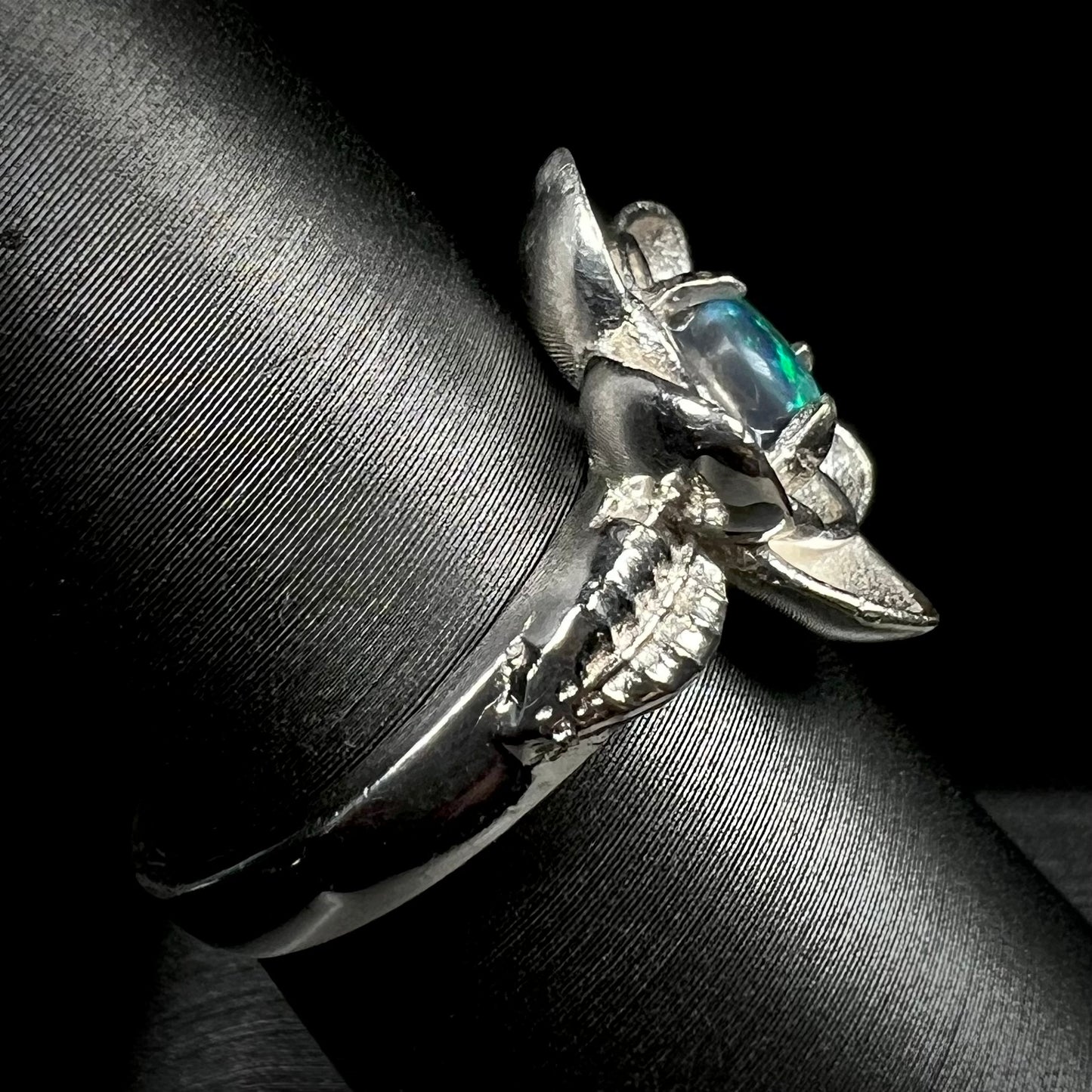 Sterling silver black opal women's ring with lotus flower design on ring display shown from side view
