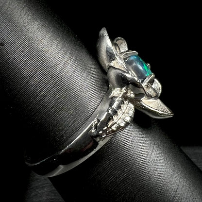 Sterling silver black opal women's ring with lotus flower design on ring display shown from side view