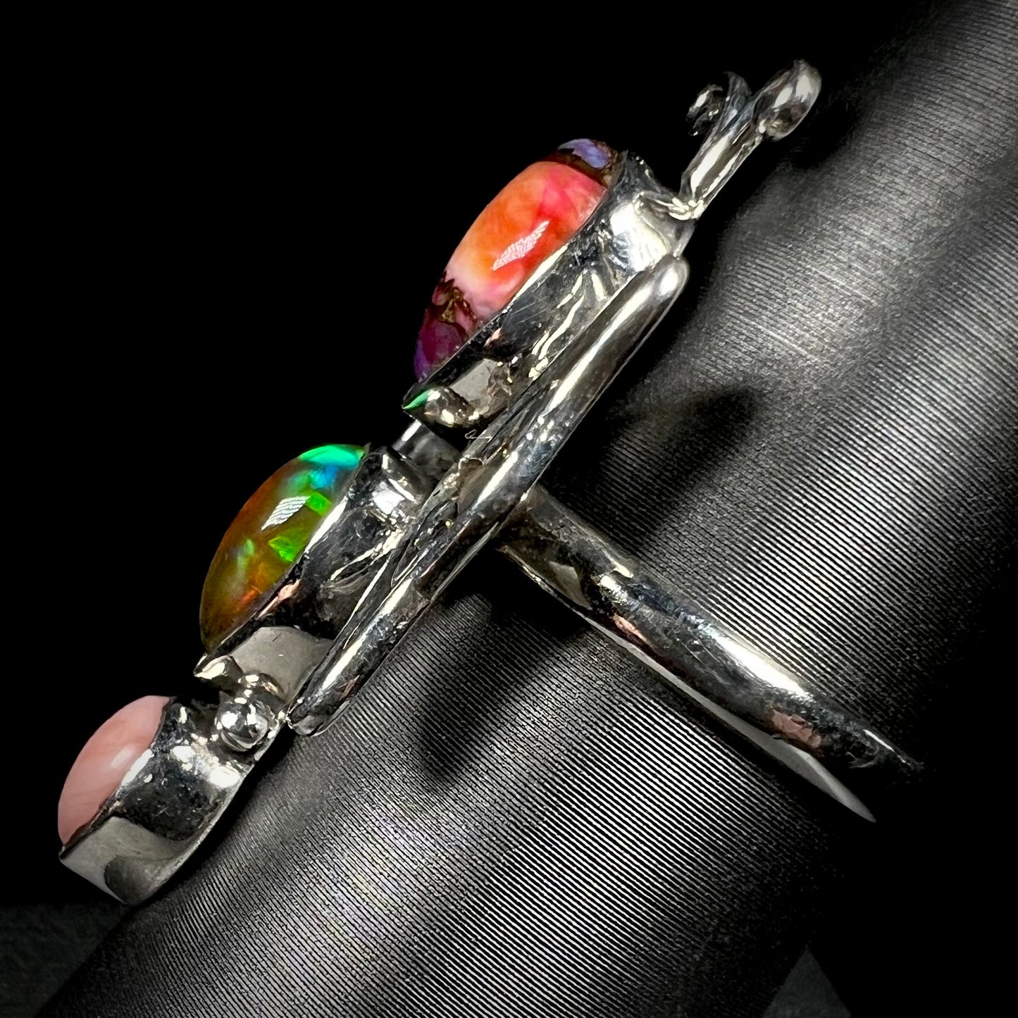 Side view of a sterling silver butterfly ring shown from the side view.